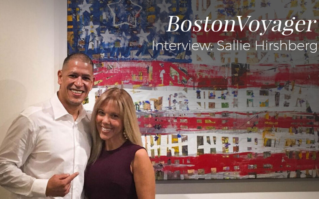 A smiling man and woman pose in front of a Boston-themed artwork.
