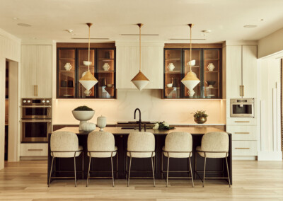 Elegant kitchen with a large island and modern pendant lights.