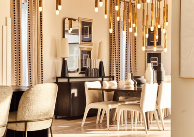 Elegant dining area with modern hanging lights and warm tones.