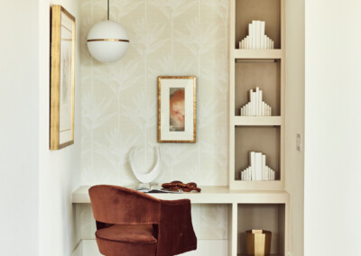 Cozy reading nook with built-in shelves and plush chair.
