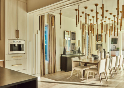 Elegant dining room with modern lighting and large windows.