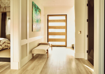 Bright hallway with wooden doors and bench.