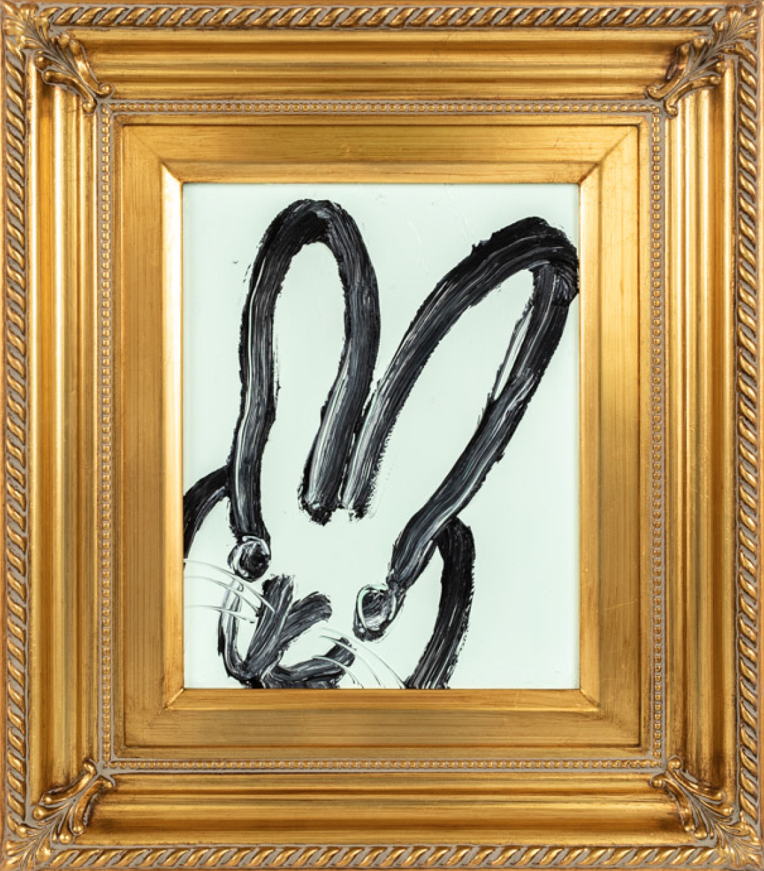 Abstract black brushstroke bunny ears in an ornate gold frame.
