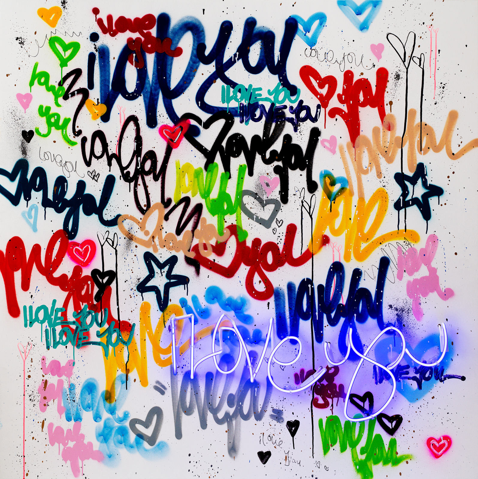 Colorful graffiti-style words and doodles on a white wall.